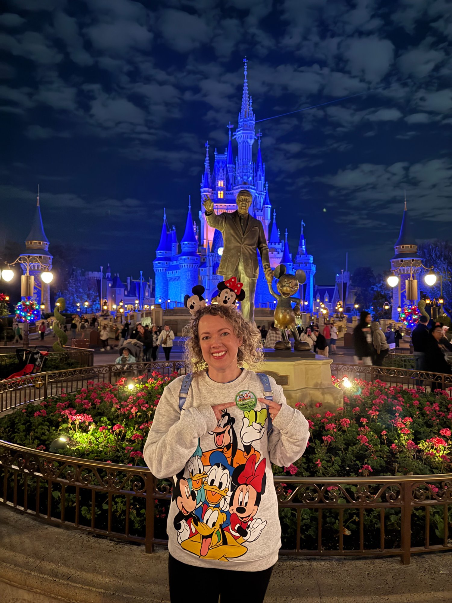 Abigail Haggard smiling in front of Cinderella Castle at Magic Kingdom at night